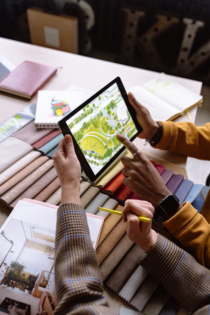 Strona główna Two architects working on a project, using a tablet to review landscape designs.